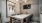 desk space with multiple swivel chairs and grey colored accent walls