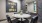 desk space with multiple chairs and grey colored accent walls