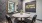 desk space with multiple chairs and grey colored accent walls