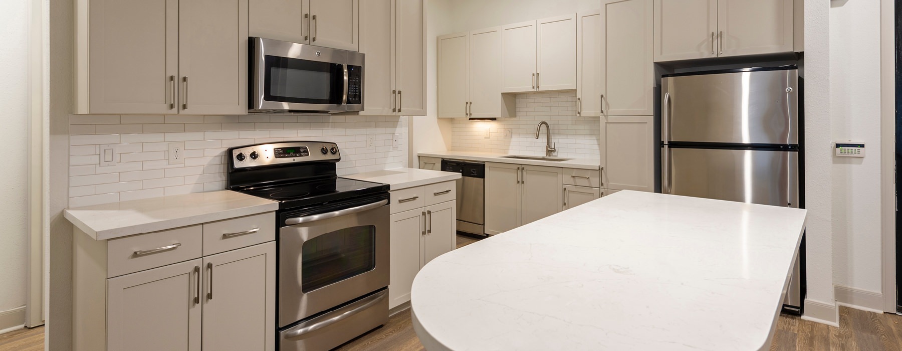well lit open kitchen with island countertop