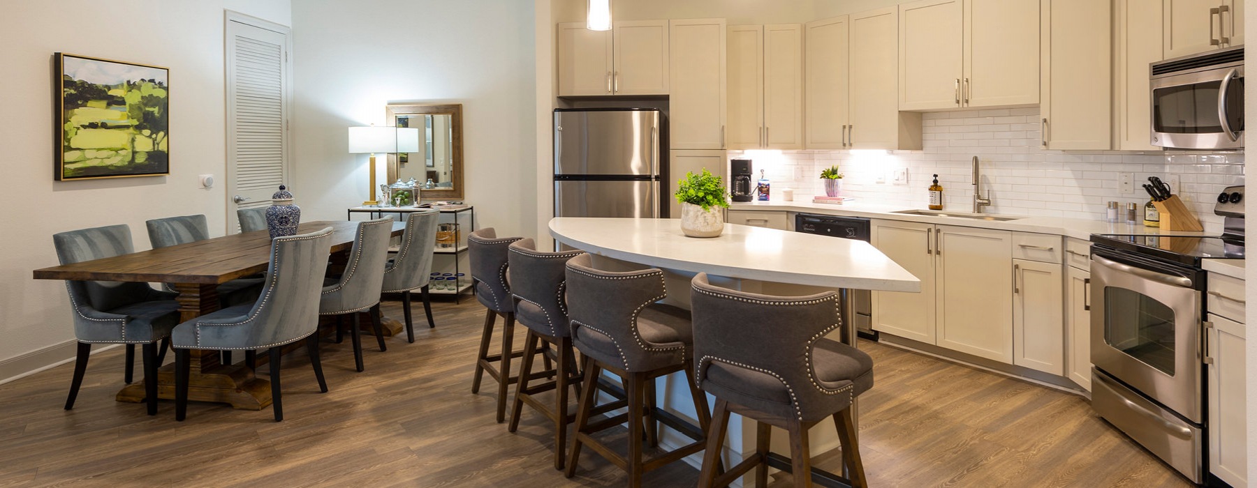open kitchen and dining areas brightly lit by overhead fixtures