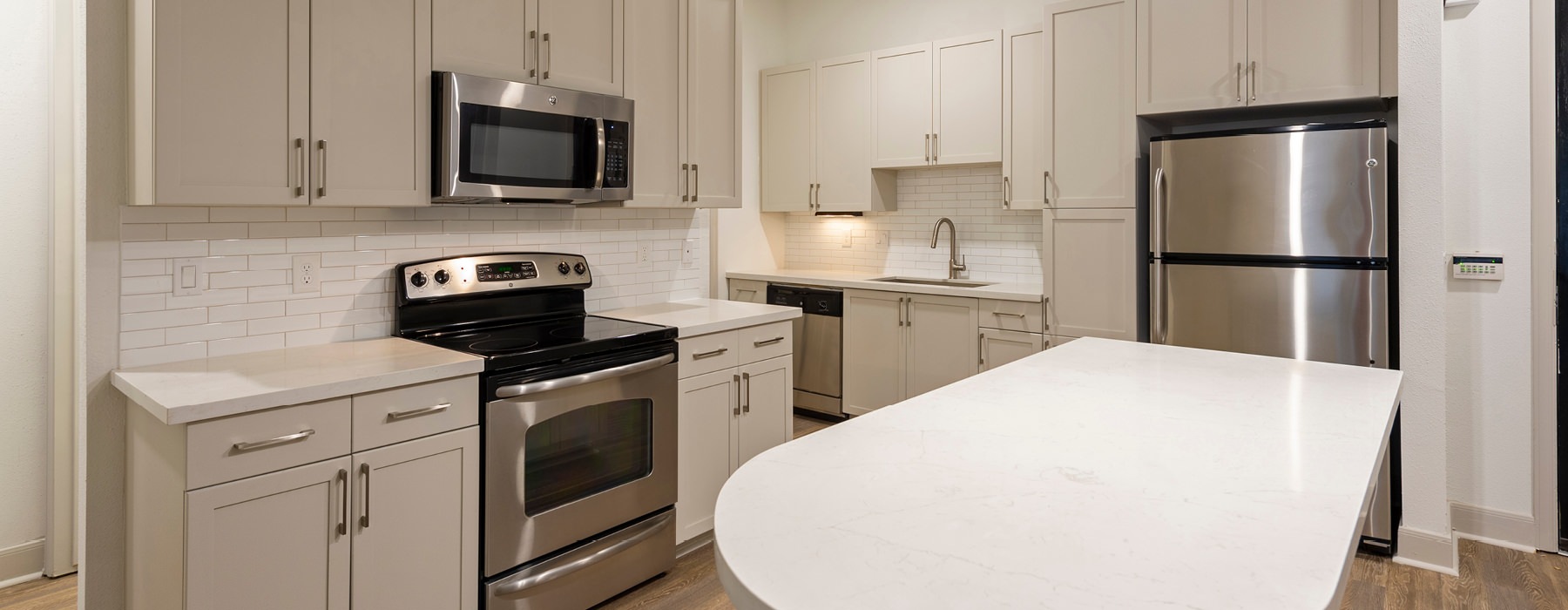 well lit open kitchen with island countertop